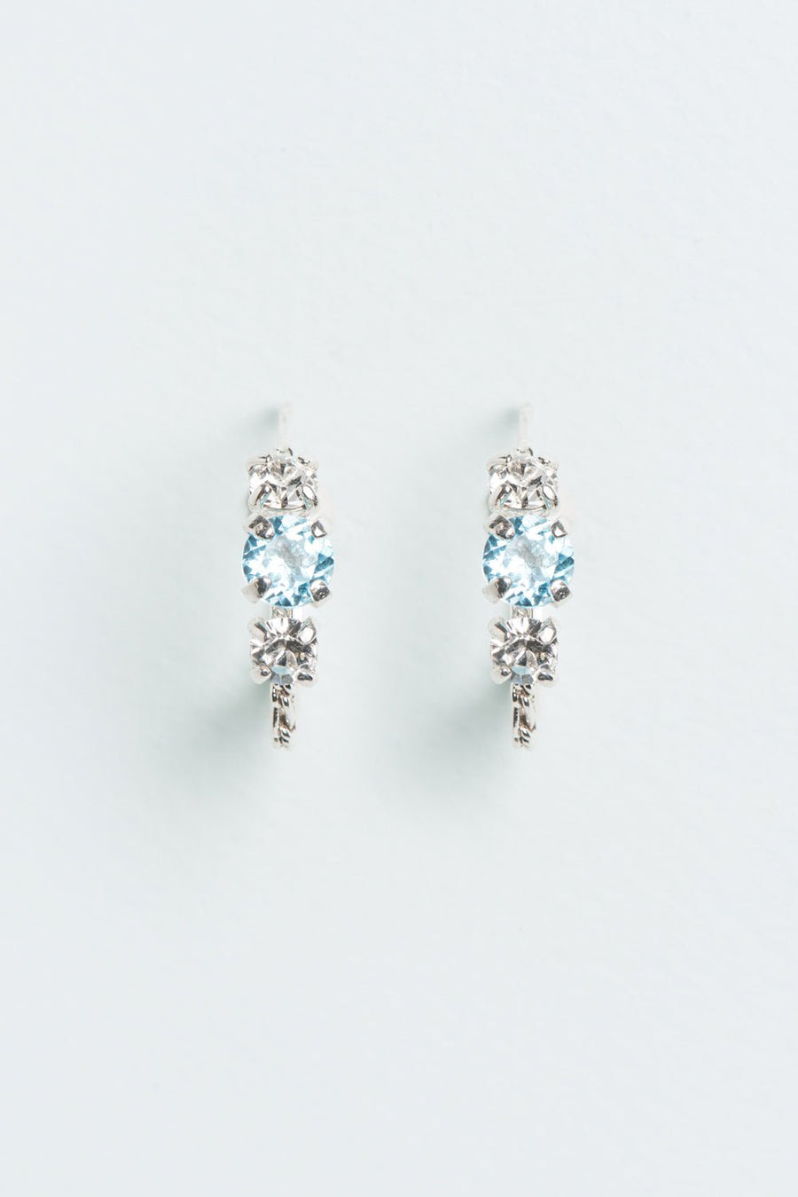 Wouters & Hendrix - Silver Hoop Earrings with Aquamarine and Clear Crystal Trilogy Stones