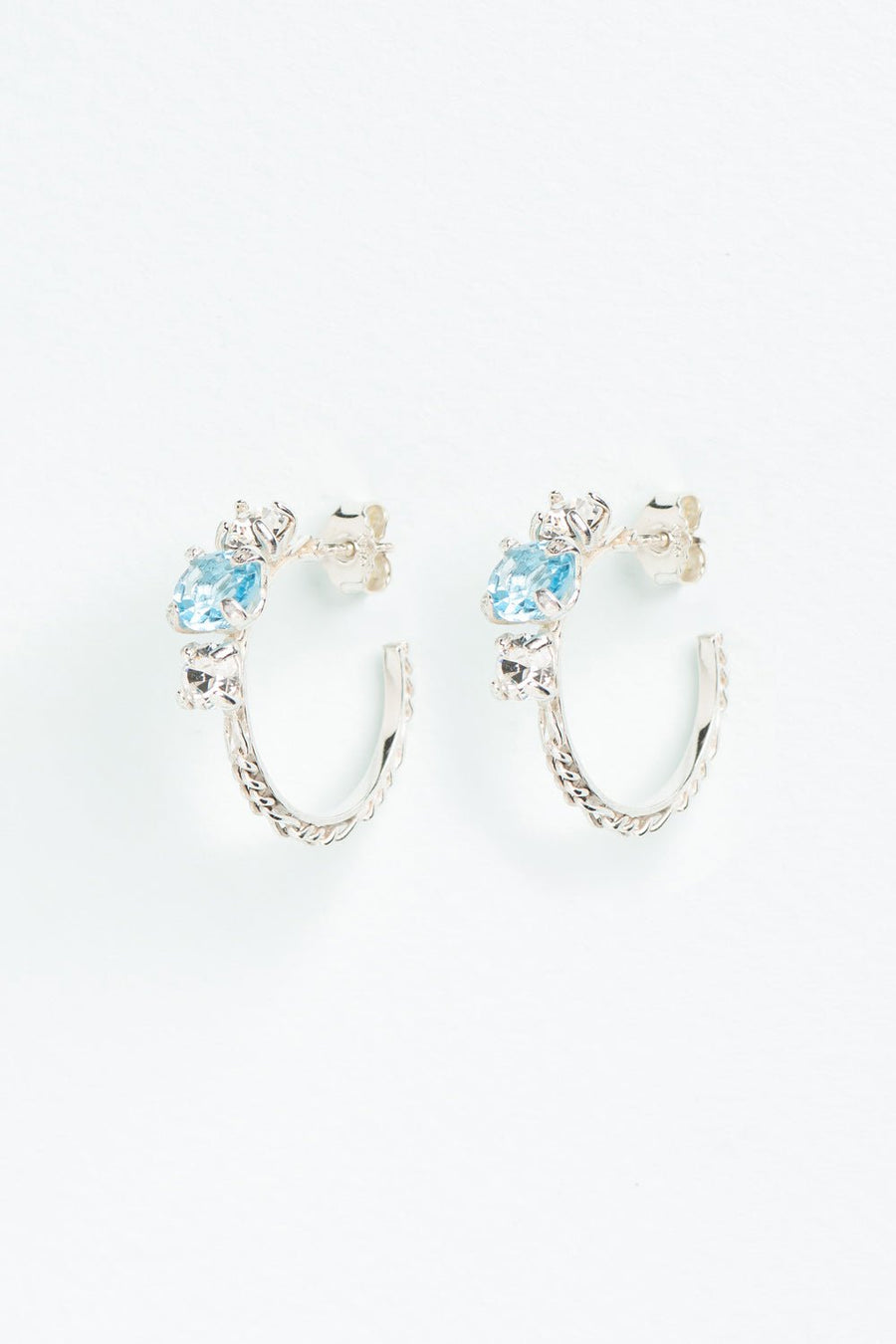 Wouters & Hendrix - Silver Hoop Earrings with Aquamarine and Clear Crystal Trilogy Stones